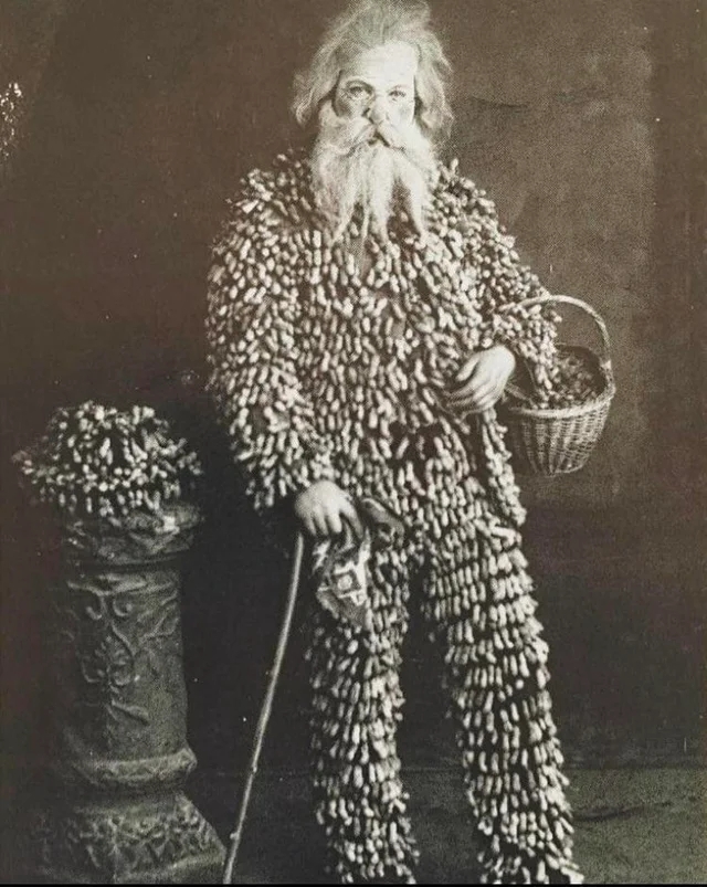 Peanut vendor wearing a suit made of peanuts (1890)